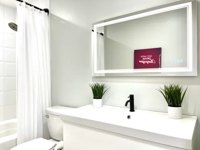 a bedroom with a bed dresser and a window