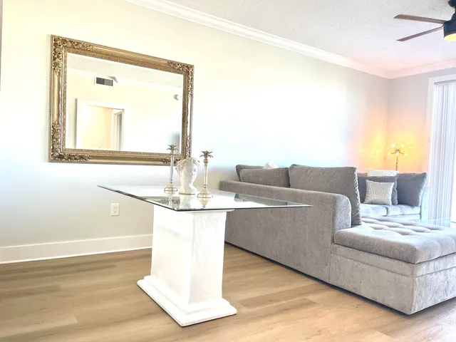 a living room with furniture and a floor to ceiling window