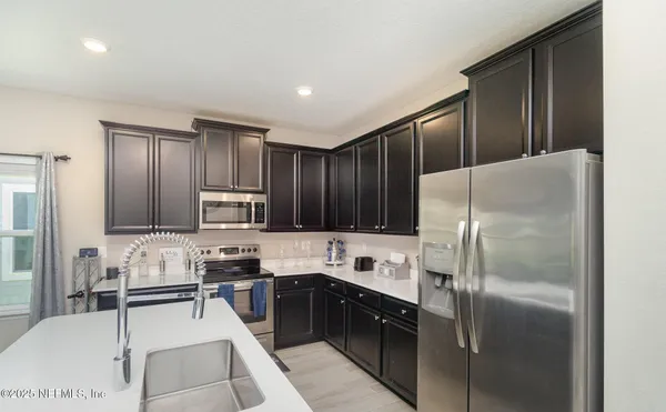 a kitchen with granite countertop stainless steel appliances and wooden cabinets
