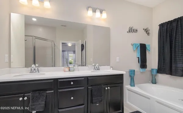 a bathroom with a double vanity sink and a mirror
