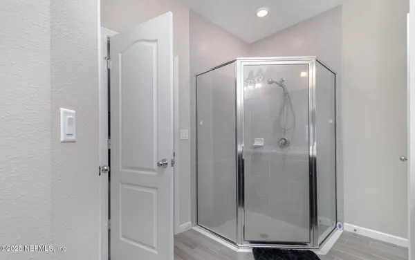 a bathroom with a glass shower door