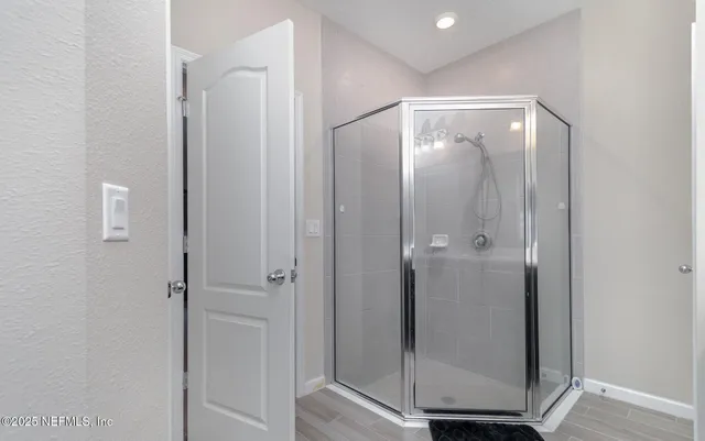 a bathroom with a glass shower door