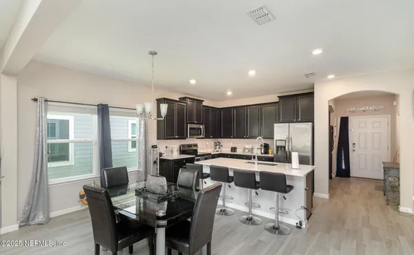 a view of a dining room with furniture window and wooden floor