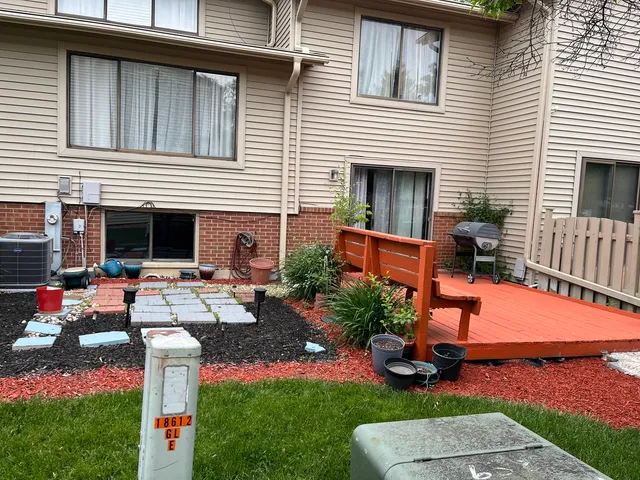 a view of a house with backyard sitting area and furniture
