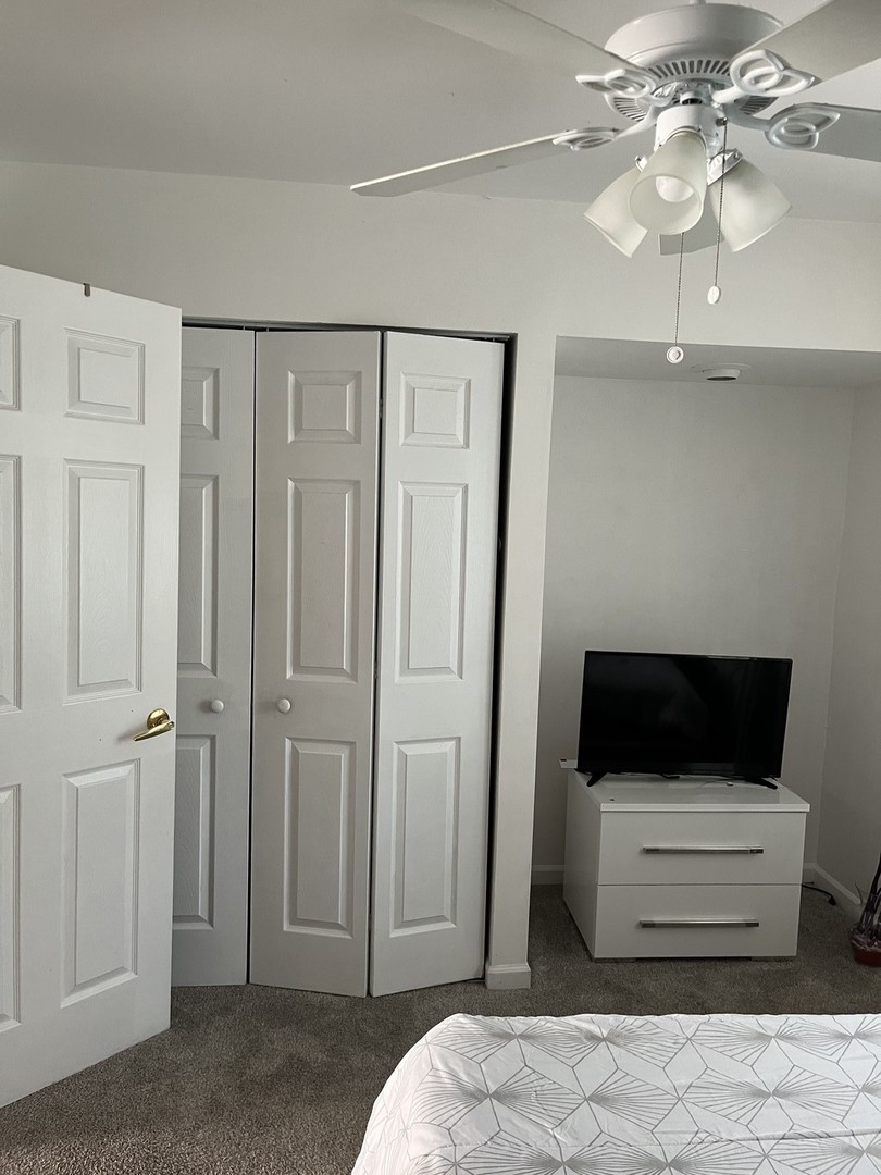 18650 Golfview Drive Hazel Crest, IL 60429 - Photo 12 of 35 a bedroom with a bed and a chandelier