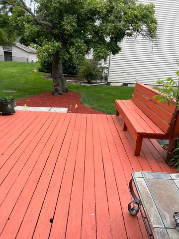 a view of backyard with wooden floor and fence
