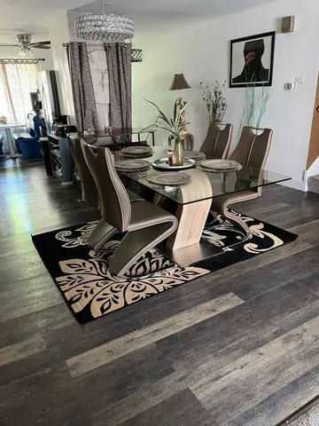 a room with gym equipment and wooden floor