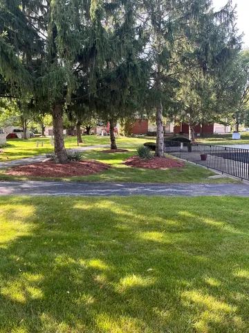 a view of swimming pool with outdoor seating and trees