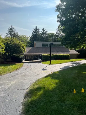 a view of a swimming pool with a yard and palm trees