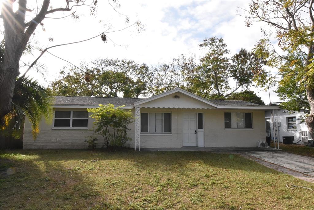 7524 Galahad Road Port Richey, FL 34668 - Photo 1 of 26 front view of house with a yard