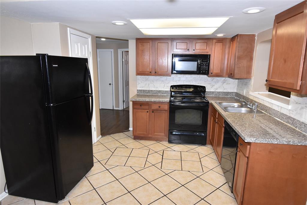 7524 Galahad Road Port Richey, FL 34668 - Photo 8 of 26 a kitchen with granite countertop a refrigerator stove and oven