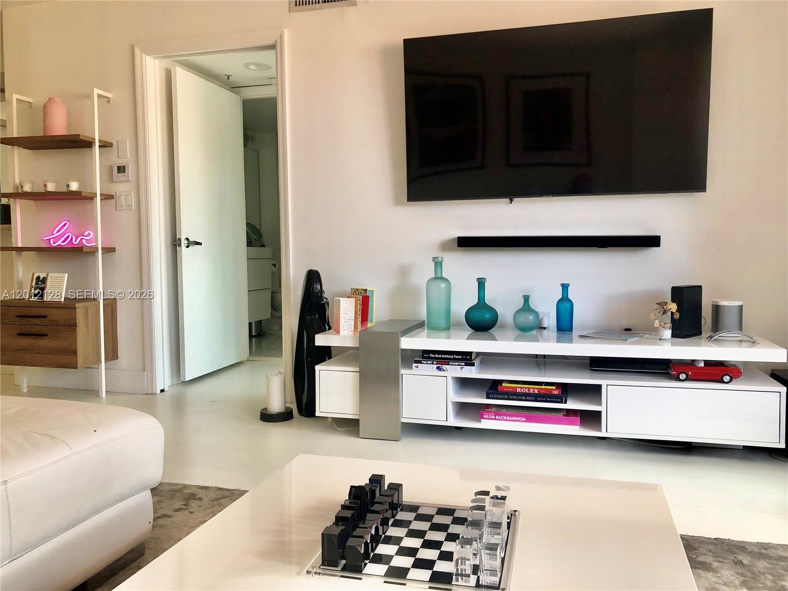 90 Alton Road, Unit 307 Miami Beach, FL 33139 - Photo 1 of 11 a bedroom with bed and a couch