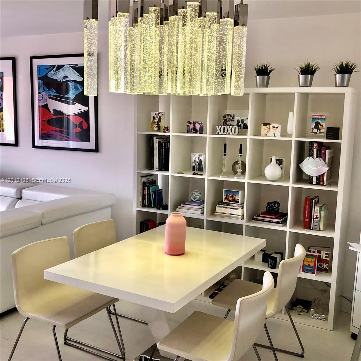 90 Alton Road, Unit 307 Miami Beach, FL 33139 - Photo 2 of 11 a kitchen with a table and chairs in it
