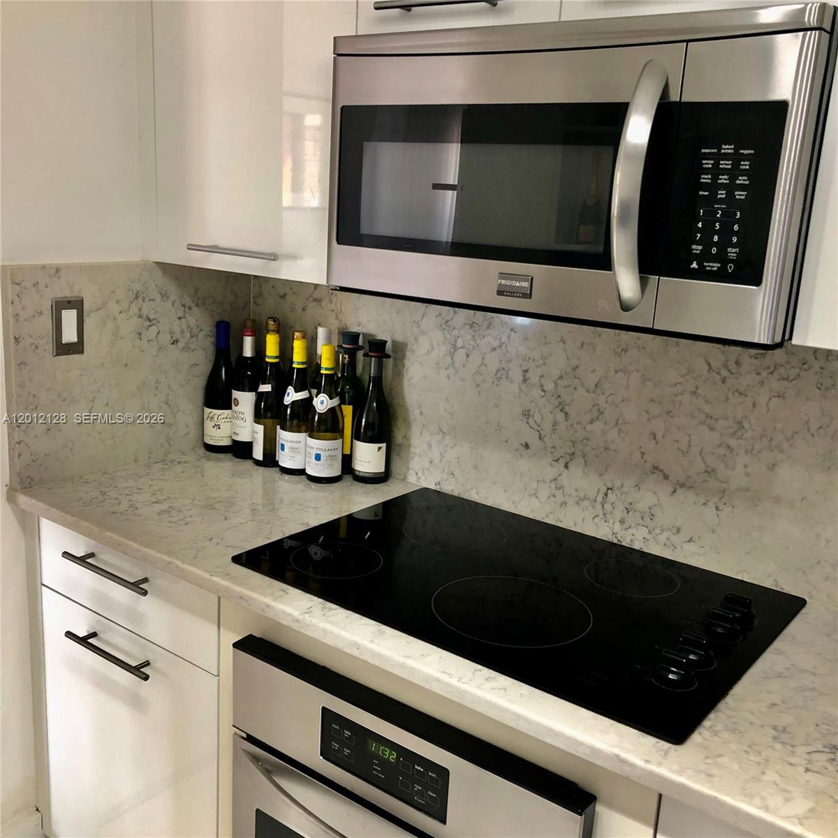 90 Alton Road, Unit 307 Miami Beach, FL 33139 - Photo 3 of 11 a kitchen with a sink and cabinets