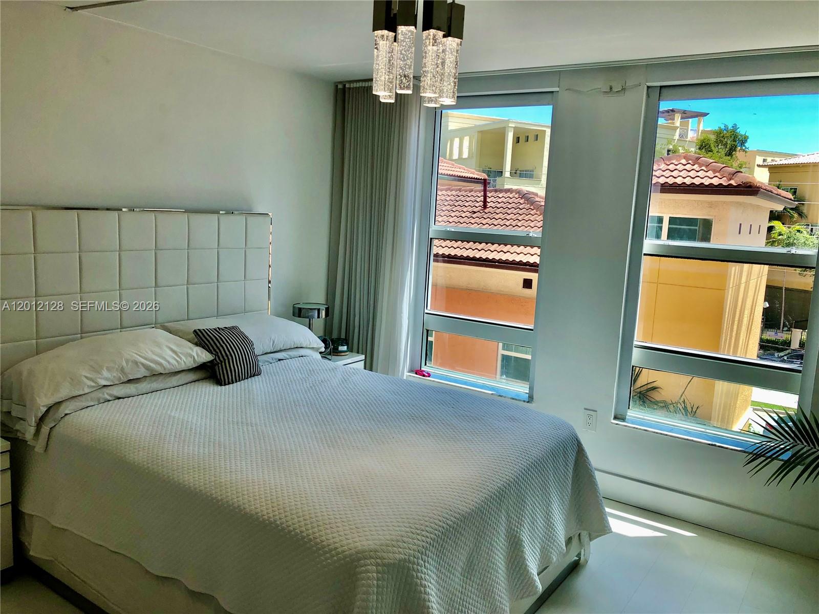 90 Alton Road, Unit 307 Miami Beach, FL 33139 - Photo 10 of 11 a bedroom with a bed and window