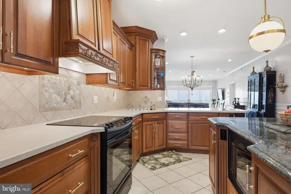 a kitchen with stainless steel appliances granite countertop a sink and dishwasher a stove top oven with wooden floor