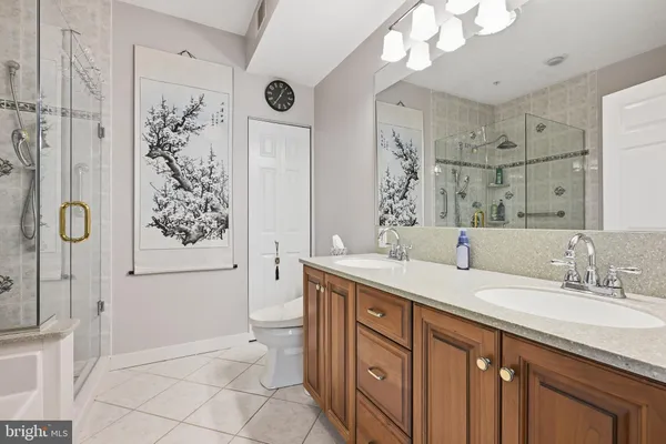 a spacious bathroom with a granite countertop sink toilet and shower