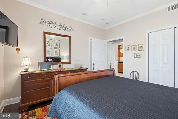 a large kitchen with cabinets and a bed