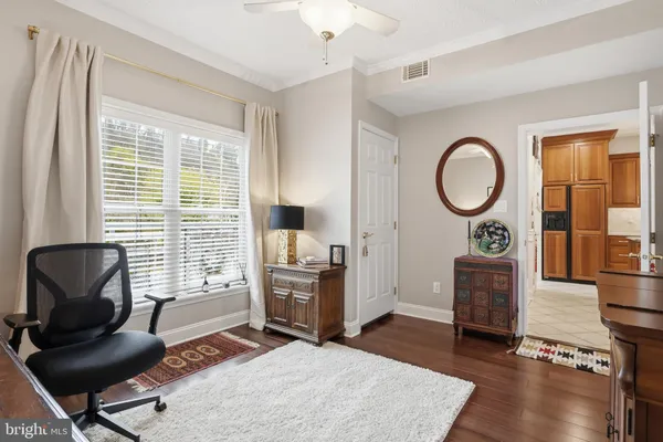 a view of a livingroom with workspace and a window