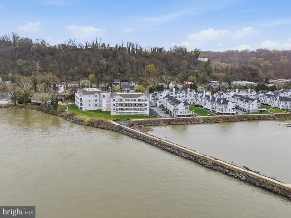 a view of a house with a yard and lake view