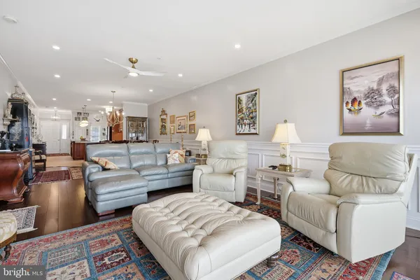 a living room with furniture and a lamp