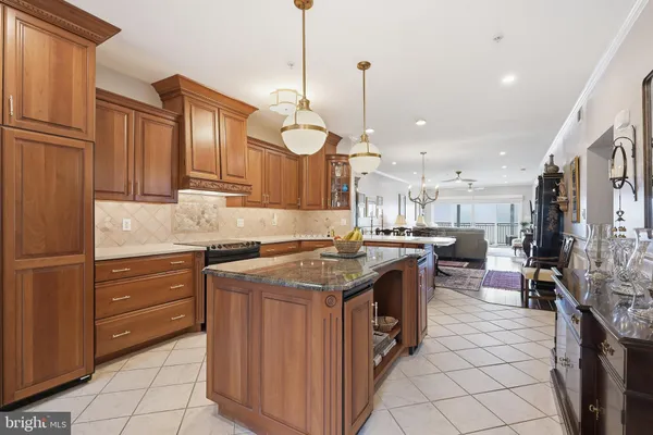 a kitchen with stainless steel appliances granite countertop a stove a sink dishwasher and a refrigerator