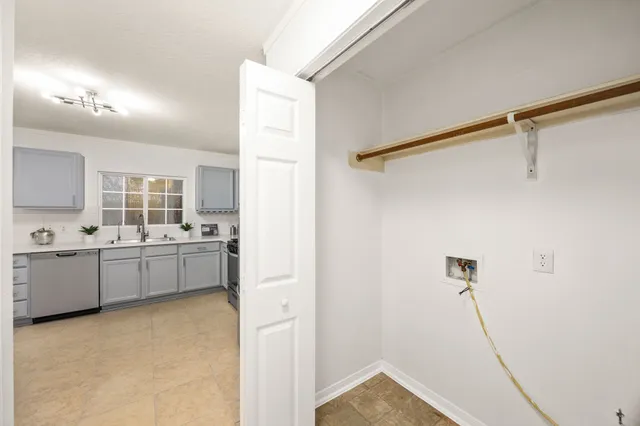 a kitchen with a refrigerator and white cabinets