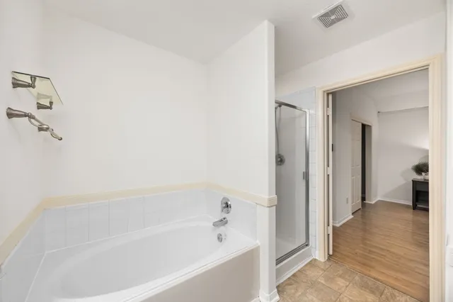 a bathroom with a bathtub and a shower