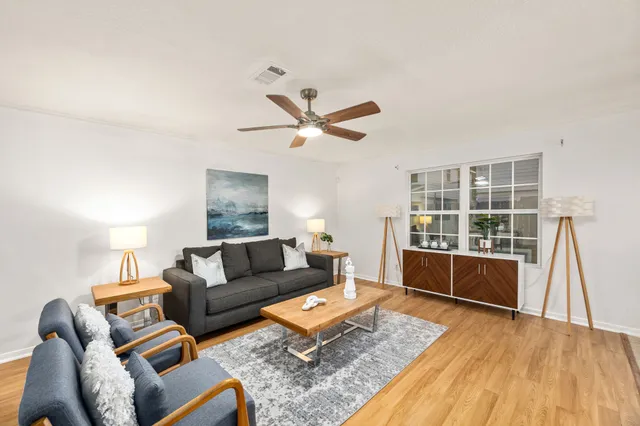 a living room with a couch and a wooden floor