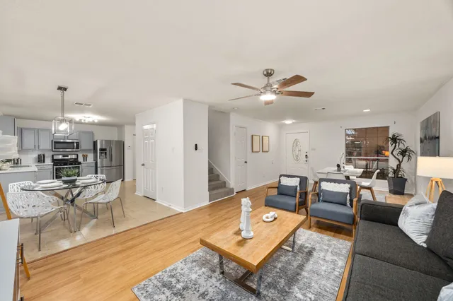 a living room with furniture and kitchen view