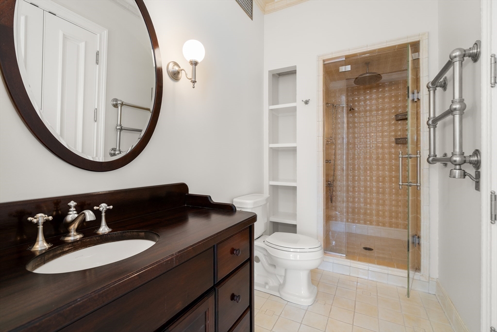 357-359 Beacon Street, Unit 4 Boston, MA 02116 - Photo 7 of 12 a bathroom with a sink a toilet and a mirror