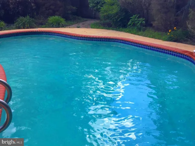 a view of swimming pool from a yard