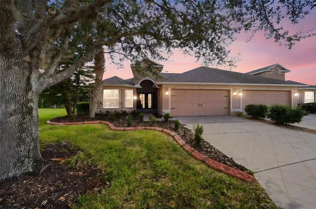 a kitchen with white cabinets stainless steel appliances and window