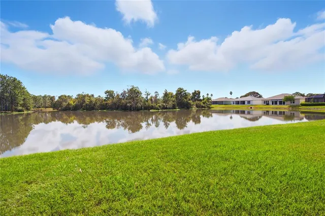 a view of a lake with houses in the back