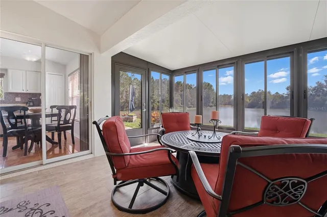a room with furniture pool table and a flat screen tv