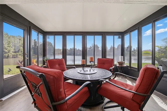 a dining room with furniture a chandelier and wooden floor
