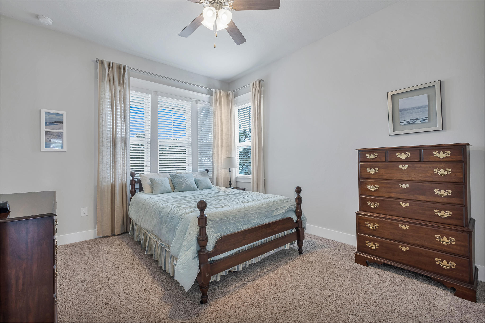 91 Grande Pointe Circle Inlet Beach, FL 32461 - Photo 37 of 49 a bed sitting in a bedroom next to a window and a chandelier
