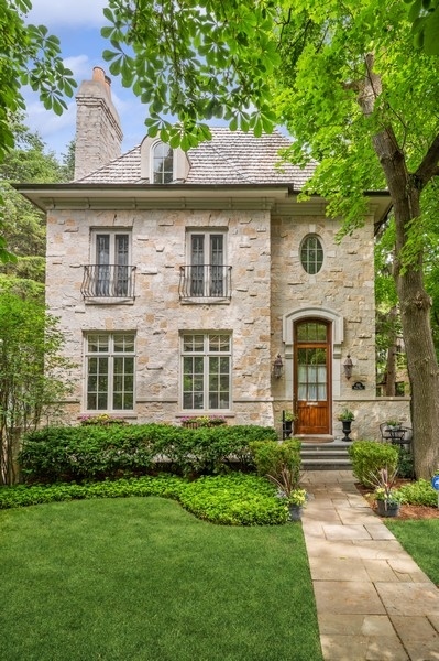 a front view of a house with a garden