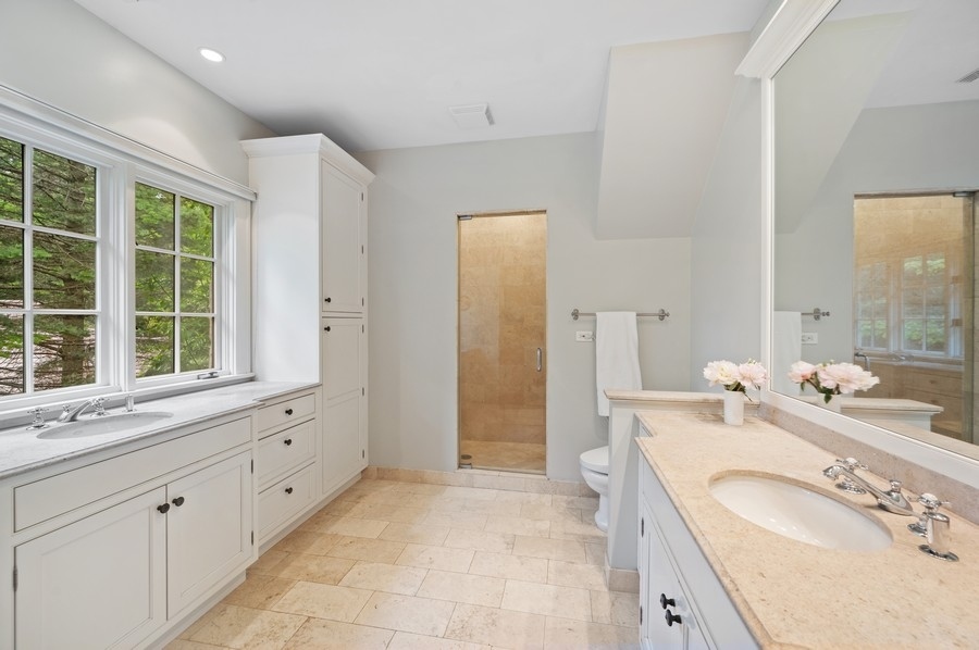 501 Ridge Road Kenilworth, IL 60043 - Photo 21 of 46 a spacious bathroom with double vanity sink a mirror and a shower