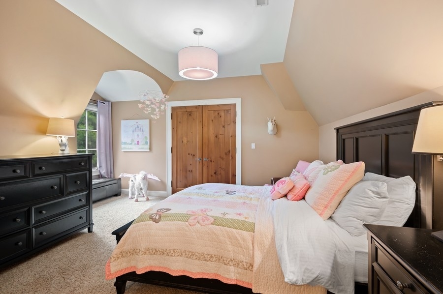 501 Ridge Road Kenilworth, IL 60043 - Photo 26 of 46 a bedroom with a bed and wooden floor
