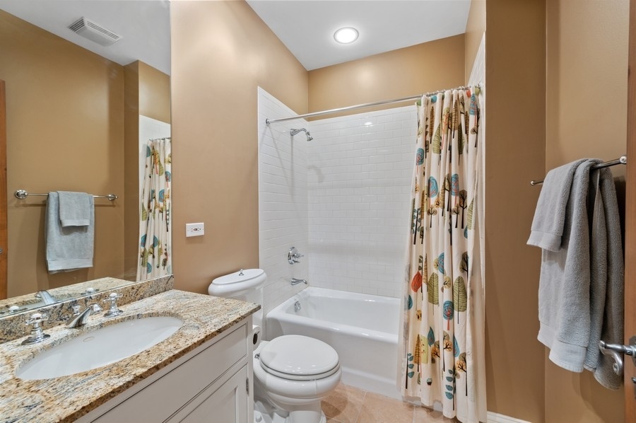 501 Ridge Road Kenilworth, IL 60043 - Photo 27 of 46 a bathroom with a granite countertop sink toilet and shower