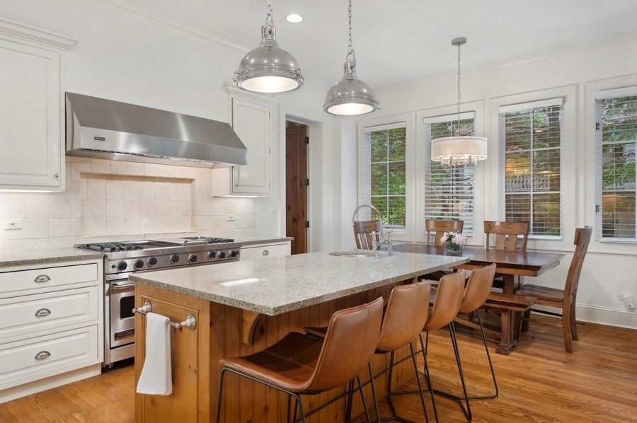 501 Ridge Road Kenilworth, IL 60043 - Photo 6 of 46 a kitchen with a stove a table and chairs in it