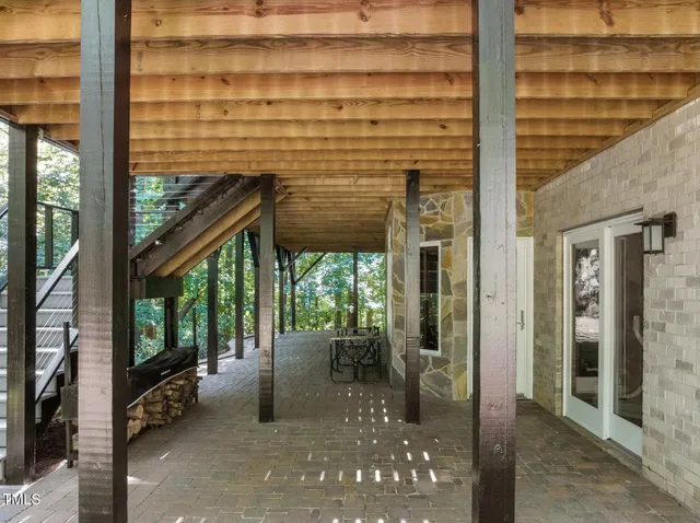 a living room with fireplace furniture and a large window