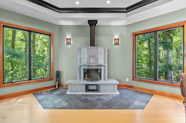 a dining room with furniture a chandelier and wooden floor