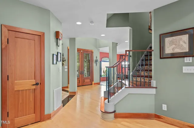 a kitchen with stainless steel appliances kitchen island granite countertop a stove a refrigerator a kitchen island with a dining table and chairs