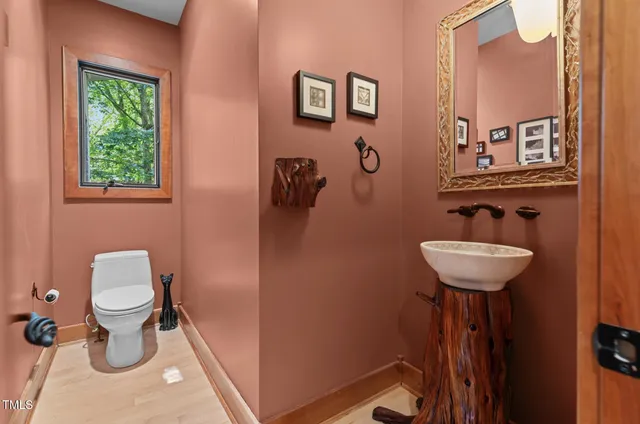 a view of a hallway with wooden floor and windows