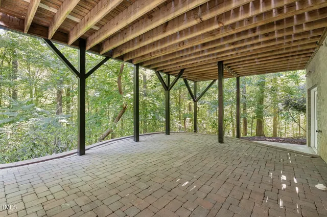 a bedroom with a bed and a desk next to a window