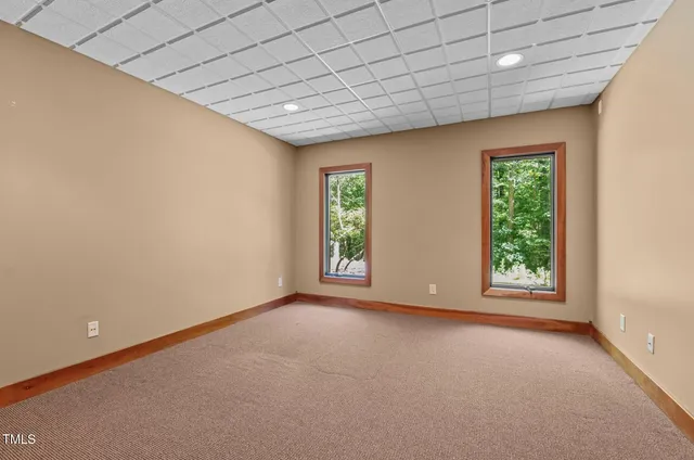 a bathroom with a granite countertop sink toilet mirror and bathtub
