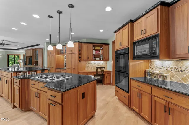 a view of an empty room with window a ceiling fan and front door