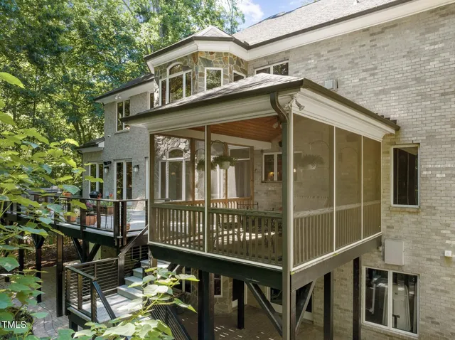 a living room with furniture fireplace and a large window